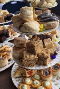 Afternoon tea stand with scones, cakes, and pastries, perfect for catering events in Surrey.