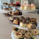 Afternoon tea stand featuring sausage rolls and quiches, ideal for event catering in Surrey.