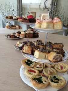 Afternoon tea stand featuring sausage rolls and quiches, ideal for event catering in Surrey.